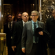 Bill Gates (front, left) exits an elevator before speaking to reporters at Trump Tower in New York City on Dec. 13, 2016.